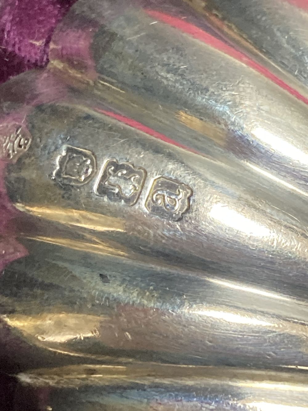 A cased pair of late Victorian silver serving spoons, with shell bowls and figural terminals,